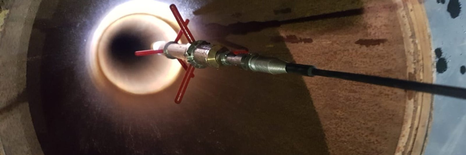 Borehole camera tool inside a well casing
